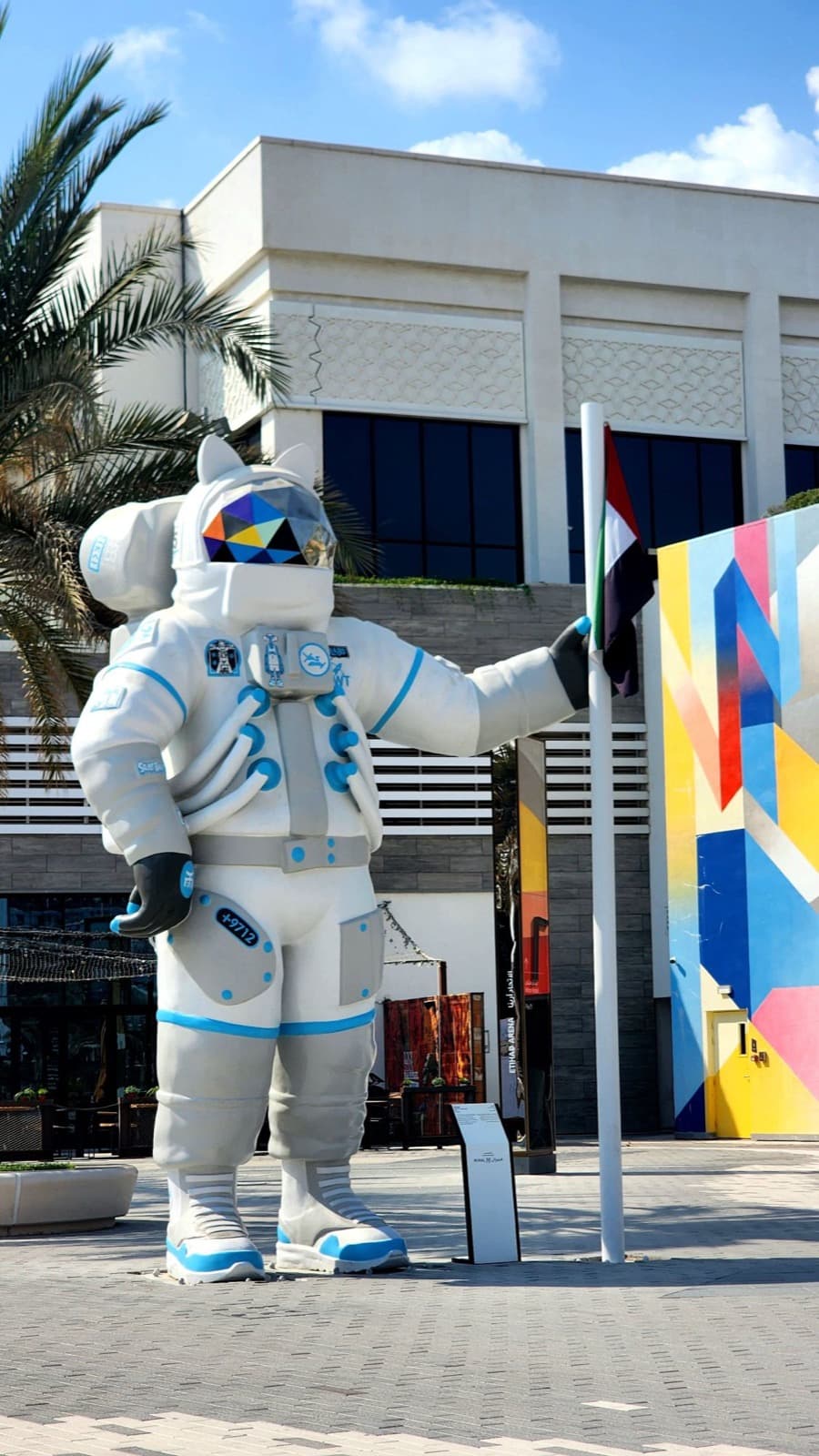 An astronaut sculpture holding the UAE flag